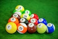 Shot of foot pool balls standing on green table.