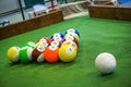 Shot of foot pool balls standing on green table.
