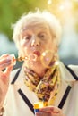 Shes a golden oldie. Shot of a fun-loving senior woman blowing bubbles outside on a sunny day. Royalty Free Stock Photo