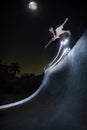 Shot of a girl skateboarding in a night skate park Royalty Free Stock Photo