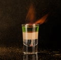 Shot glass with alcohol on a dark background