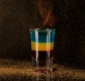Shot glass with alcohol on a dark background