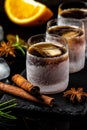 Shot glass of herb liqueur with cinnamon and oranges on dark background. Alcoholic booze cocktail. german digestif made with 56 Royalty Free Stock Photo