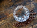 Shot glass of Sambuca, an italian alcoholic drink, with coffee beans on old wooden table