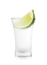 Shot glass of vodka and lime isolated on white Royalty Free Stock Photo