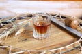 Shot glass of whiskey and spicas on wooden cask top Royalty Free Stock Photo