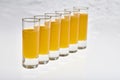 Tall Shot Glasses with orange flavoured Alcoholic shots Royalty Free Stock Photo