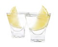 Shot glasses of vodka with lemon slices on white background Royalty Free Stock Photo