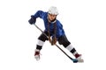 Full-length portrait of child girl, hockey player isolated over black background Royalty Free Stock Photo