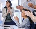 Positive thoughts create a positive environment. Shot of a group of businesspeople clapping in a meeting at work.