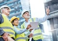 Managing a complex project together. Shot of a group of businesspeople using a digital tablet while working at a Royalty Free Stock Photo