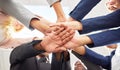 Heres to us reaching our goals. Shot of a group of coworkers huddling their hands together in team sprit.