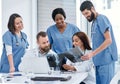 Coming together to do more thorough evaluations. Shot of a group of medical practitioners analysing x-rays in a hospital Royalty Free Stock Photo