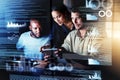 Diving into new networks. Shot of a group of programmers using a digital tablet while working together on a computer