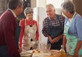 Happiness is homemade. Shot of a group of seniors cooking in the kitchen. Royalty Free Stock Photo