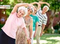 Staying active is key to a healthy retirement. Shot of a group of smiling seniors exercising outside. Royalty Free Stock Photo