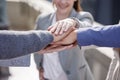 I know they have my back. Shot of a group of unrecognizable businesspeople stacking their hands together outside.