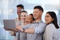 About us.... Shot of a group of young businesspeople taking selfies with a digital tablet in a modern office. Royalty Free Stock Photo