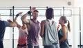 Strong people inspire other people to be strong. Shot of a group of young people motivating each other with a high five