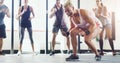 Get psyched to get strong. Shot of a group of young people standing in a circle at the gym and motivating each other.