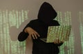 Shot of hacker using laptop. Lots of digits on the computer screen Royalty Free Stock Photo