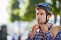 Strapped in for safety. Shot of a handsome young man preparing to take a ride by putting on a helmet. Royalty Free Stock Photo