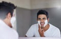 Sprucing up before a big date. Shot of a handsome young man shaving his facial hair in the bathroom. Royalty Free Stock Photo