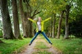 Shot of happy funny girl jumping in park at fine autumn day Royalty Free Stock Photo