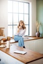 Shot of happy woman drinking her morning coffee in the kitchen at home Royalty Free Stock Photo