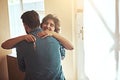 Forget keys to the house, theyre keys to a dream. Shot of a happy young couple hugging as they move into their new home.