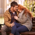 The heart that loves is always young. Shot of a happy young couple sharing an affectionate moment on a park bench.