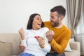 Shot of a happy young couple taking a pregnancy test at home. A Happy excited woman making positive pregnancy test and celebrating Royalty Free Stock Photo