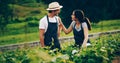 Gardening time is quality time. Shot of a happy young couple working in a garden together. Royalty Free Stock Photo