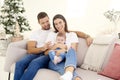 Lovely family with their baby girls relaxing on sofa at home Royalty Free Stock Photo