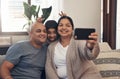 All we have is one another. Shot of a happy young family taking selfies with a smartphone on the sofa at home. Royalty Free Stock Photo