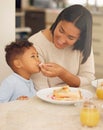 Nom nom with my mom mom. Shot of a happy young woman feeding her adorable son a sandwich during a leisurely lunch in Royalty Free Stock Photo