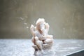 Shot of hindu god Ganesha with the heavy tropical monsoon rain drops falling on him showing the prosperity and bountiful