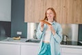 Portrait of a hungry young woman eating wholesome sandwich, having tasty breakfast in a kitchen at home in the morning Royalty Free Stock Photo