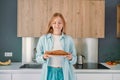 Portrait of a hungry young woman eating wholesome sandwich, having tasty breakfast in a kitchen at home in the morning Royalty Free Stock Photo