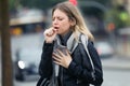 Illness young woman coughing in the street