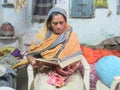 Shot of a Indian woman reading Quran
