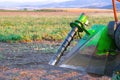 Shot of an industrial tomato picking machine working in the field on a sunny day. Royalty Free Stock Photo