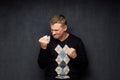 Shot of infuriated young man holding crumpled paper in hand Royalty Free Stock Photo