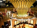 Shot inside the International Terminal at Abu Dhabi Airport with bright lights full of people