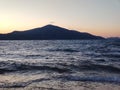 shot of the Ionian Sea from a pebble beach, with a setting sun