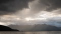 Storm clouds gathering over the lake and mountain range Royalty Free Stock Photo