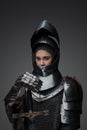 Female knight dressed in steel armor holding sword