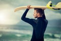 Just me and the big blue sea. Shot of a laid-back young surfer watching the waves while holding his surfboard at the Royalty Free Stock Photo