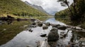 Lake in the middle of forest reflecting its surroundings