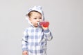 Shot of a little baby boy drinking from a sippy cup.